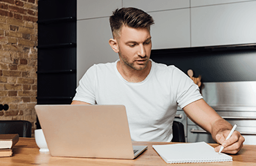 Man on laptop studying online course
