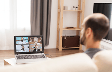 Man on couch in zoom meeting